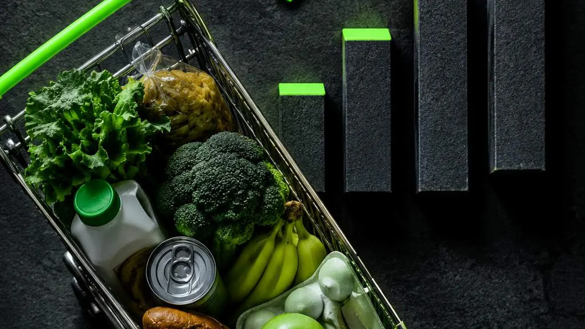 Troli belanja berisi sayur dan buah di samping grafik batang yang menanjak